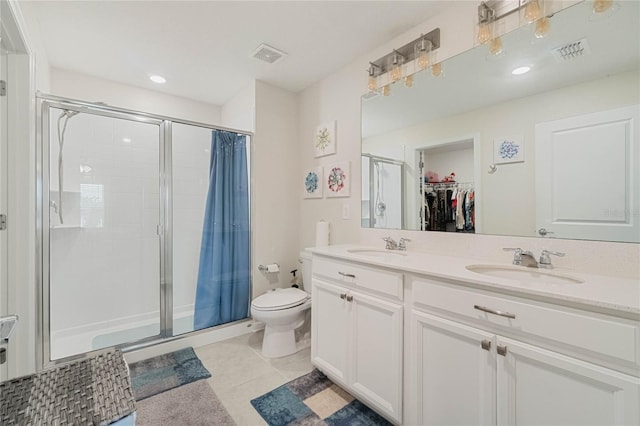 full bathroom featuring toilet, a sink, visible vents, tile patterned floors, and a stall shower