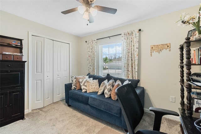 office featuring a ceiling fan and light colored carpet