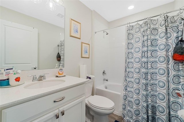 bathroom with toilet, shower / tub combo, visible vents, and vanity