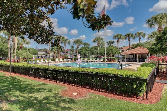 surrounding community featuring a swimming pool, a gazebo, a lawn, and fence