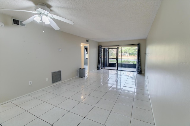 unfurnished room with a ceiling fan, visible vents, a textured ceiling, and light tile patterned flooring