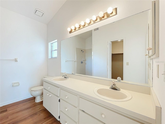 full bath with wood finished floors, a sink, toilet, and walk in shower