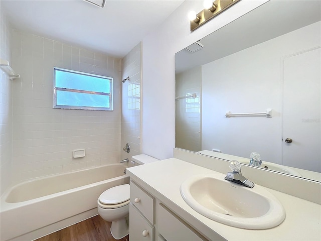 full bath featuring washtub / shower combination, vanity, toilet, and wood finished floors