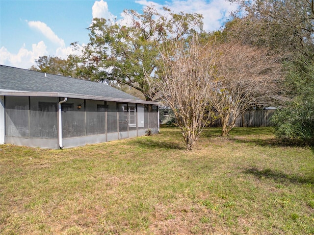 view of yard featuring a sunroom and fence