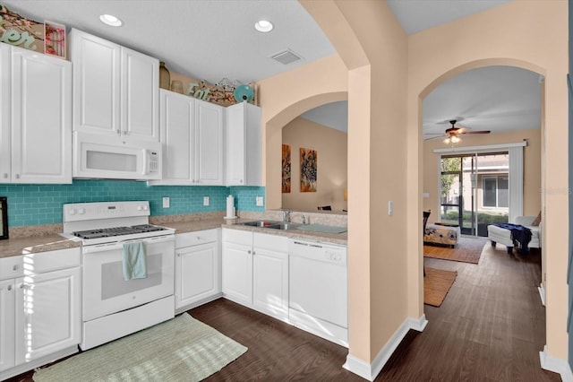 kitchen with light countertops, white appliances, dark wood-type flooring, and backsplash