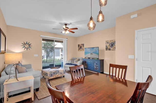 dining space featuring ceiling fan and dark wood-style flooring