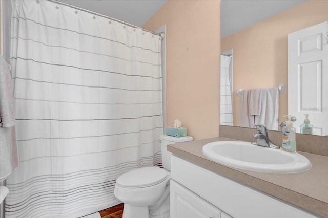 bathroom featuring wood finished floors, curtained shower, vanity, and toilet