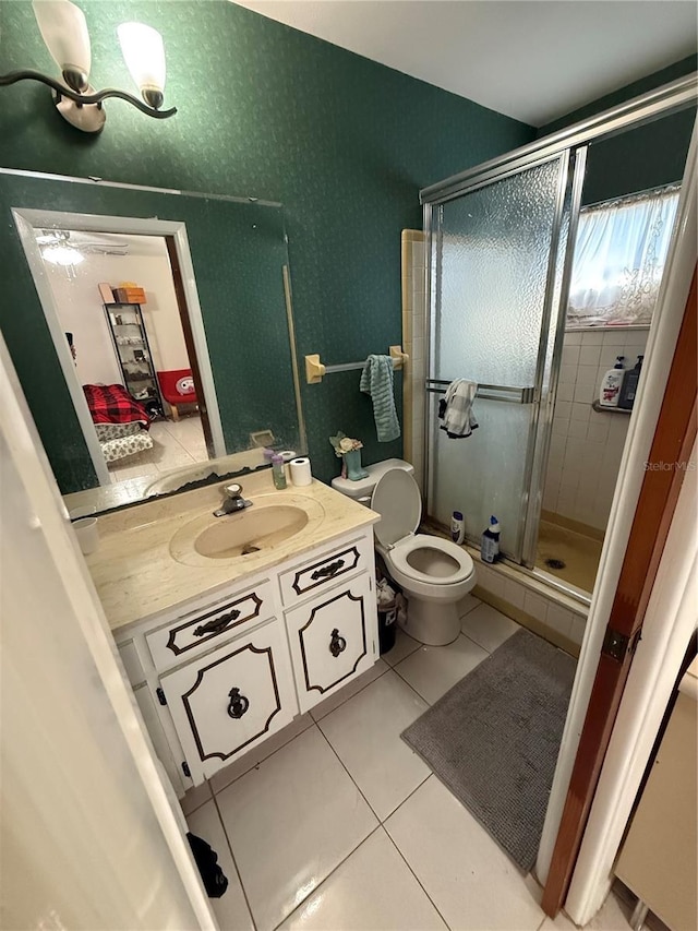 bathroom with toilet, a stall shower, vanity, and tile patterned floors