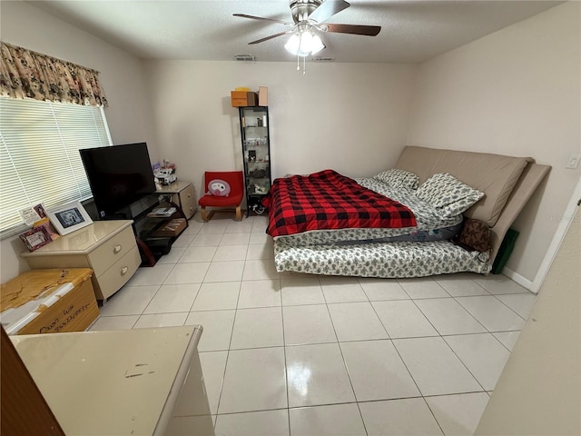 bedroom featuring light tile patterned floors and ceiling fan