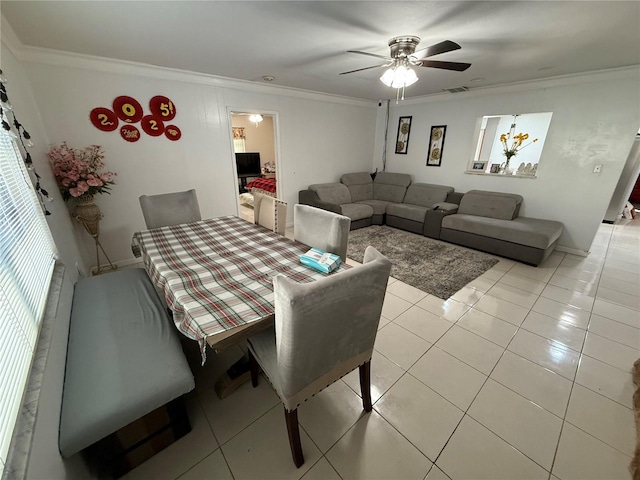 dining area featuring light tile patterned flooring, crown molding, and ceiling fan