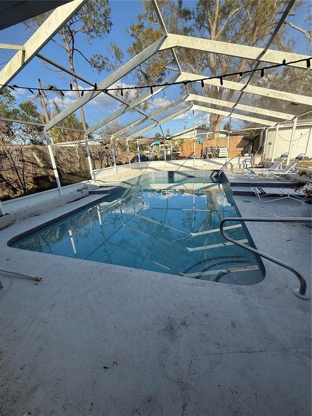 outdoor pool featuring a lanai and a patio area