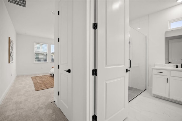 full bathroom featuring vanity, plenty of natural light, a shower stall, and visible vents