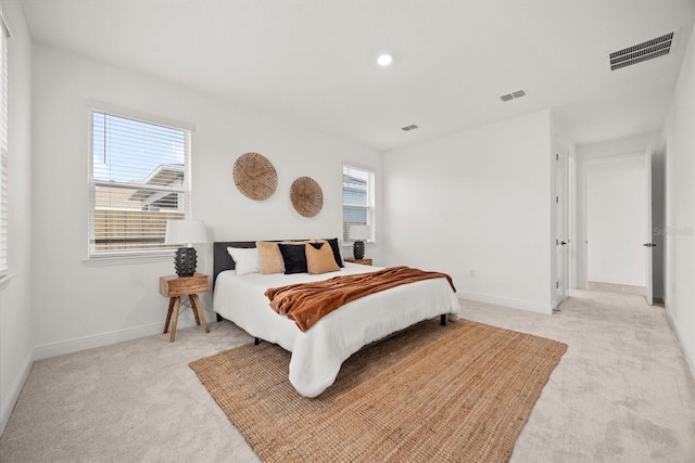 bedroom with carpet, visible vents, and baseboards