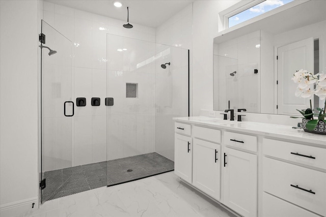 bathroom featuring marble finish floor, a shower stall, and vanity