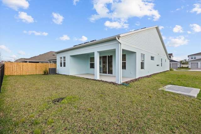 back of property featuring a yard, a patio area, fence, and stucco siding