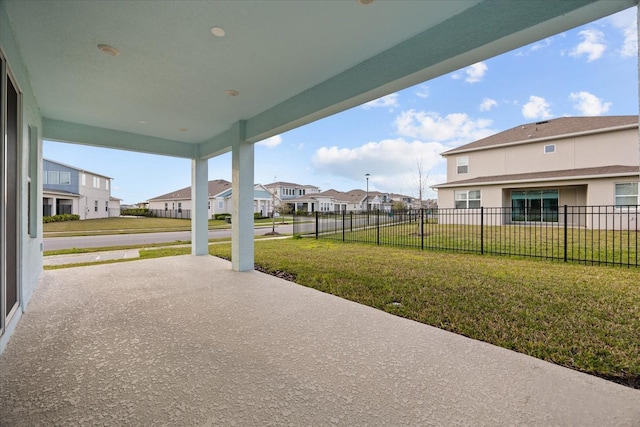 view of patio / terrace with a residential view and fence