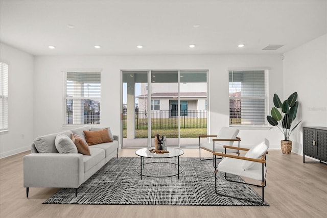 19307 Banfield Pl, Orlando, FL 32827 - living room featuring wood finished floors, recessed lighting, visible vents, and baseboards