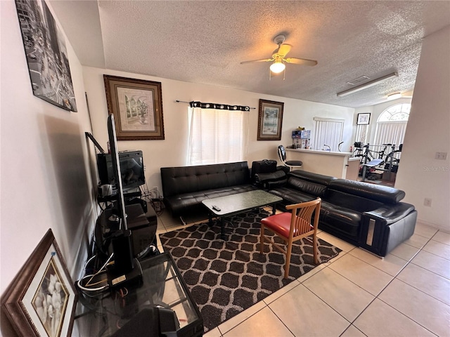 4954 Luna Negra Dr, Orlando, FL 32811 - tiled living room with a textured ceiling and a ceiling fan