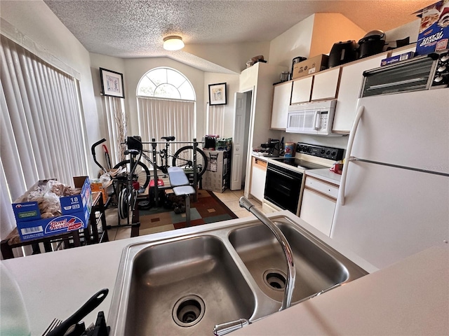 4954 Luna Negra Dr, Orlando, FL 32811 - kitchen featuring a textured ceiling, white appliances, a sink, white cabinetry, and light countertops