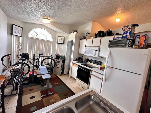4954 Luna Negra Dr, Orlando, FL 32811 - kitchen with white appliances, light tile patterned floors, light countertops, white cabinetry, and a sink
