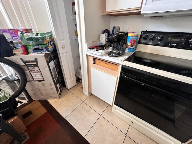 4954 Luna Negra Dr, Orlando, FL 32811 - kitchen featuring light countertops, black / electric stove, and light tile patterned floors
