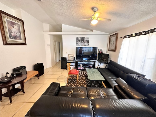 4954 Luna Negra Dr, Orlando, FL 32811 - living area with light tile patterned floors, a ceiling fan, vaulted ceiling, and a textured ceiling