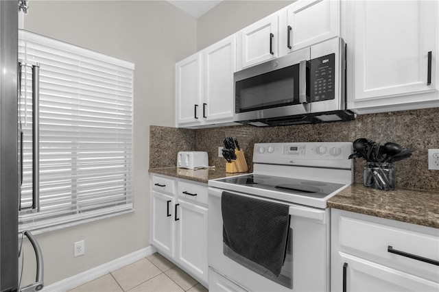 kitchen featuring white cabinets, stainless steel appliances, decorative backsplash, and light tile patterned flooring