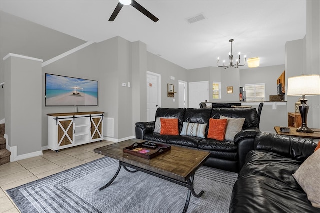 living room with ceiling fan with notable chandelier, visible vents, stairway, and tile patterned floors