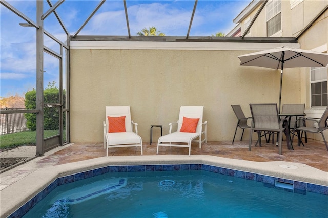 view of pool with a fenced in pool, glass enclosure, a patio, and fence