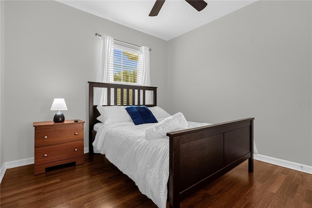 bedroom with a ceiling fan, baseboards, and wood finished floors