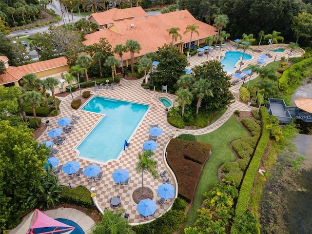 pool featuring a community hot tub and a patio area