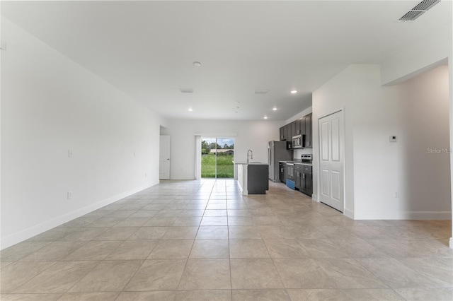 unfurnished living room with light tile patterned flooring, recessed lighting, visible vents, and baseboards