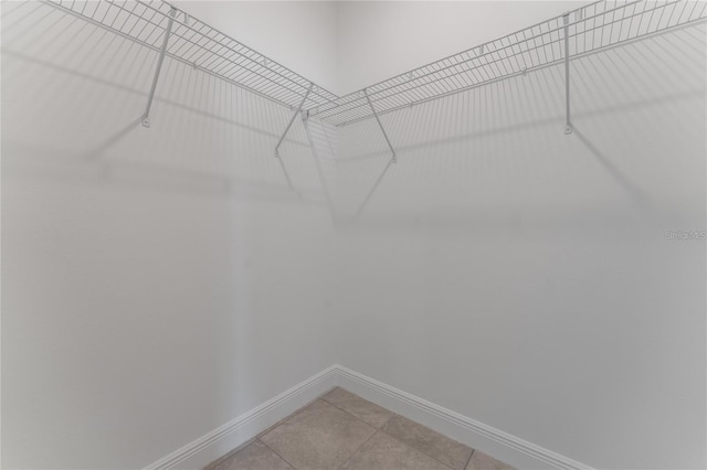 spacious closet with light tile patterned floors