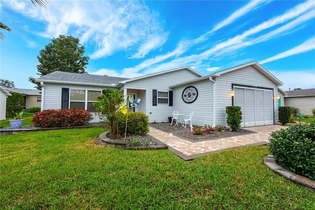 single story home with driveway, an attached garage, and a front yard