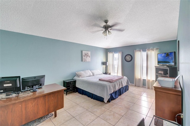 bedroom with a ceiling fan, light tile patterned flooring, and a textured ceiling