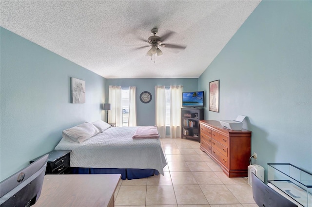 bedroom featuring a textured ceiling, light tile patterned flooring, lofted ceiling, and a ceiling fan