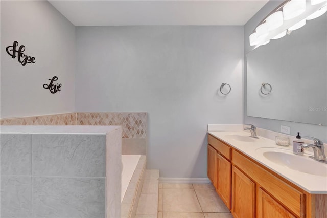 bathroom featuring double vanity, tile patterned flooring, a sink, and a tub