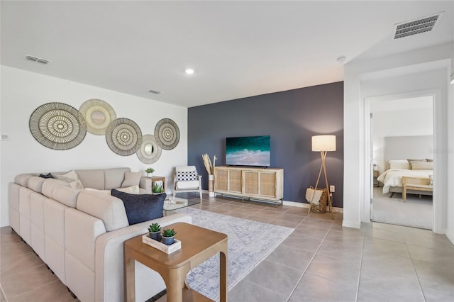 tiled living area with baseboards, visible vents, and recessed lighting