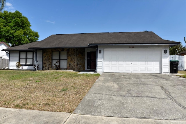 single story home featuring fence, roof with shingles, an attached garage, a front lawn, and concrete driveway