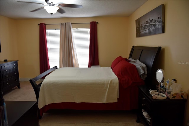 bedroom with baseboards, carpet floors, and a ceiling fan