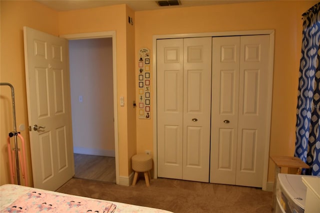 bedroom with a closet, baseboards, and carpet