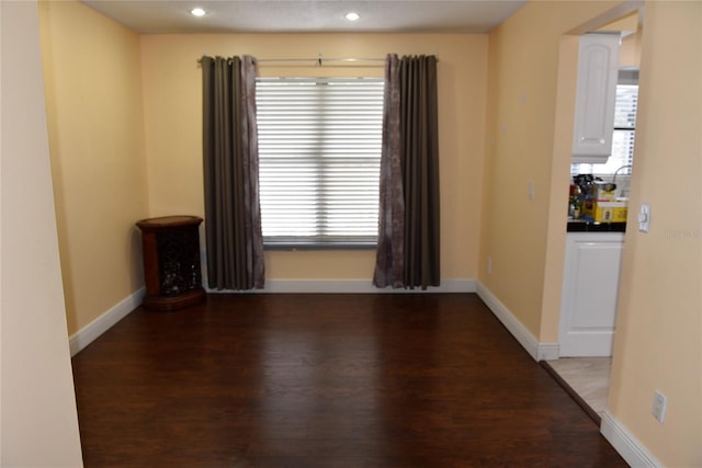 spare room featuring recessed lighting, baseboards, and wood finished floors