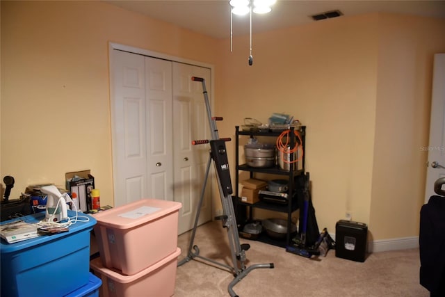 office featuring baseboards, visible vents, and light carpet