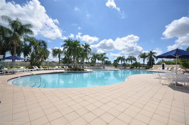 pool featuring a patio area and fence