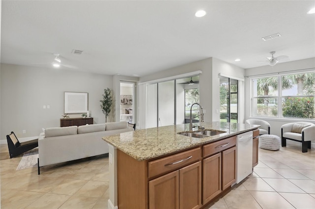 kitchen featuring dishwasher, visible vents, open floor plan, and a sink