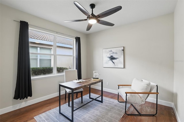 office space featuring wood finished floors, a ceiling fan, and baseboards