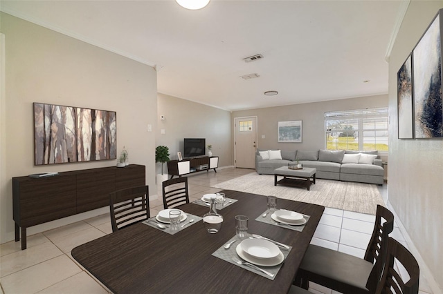 dining space featuring ornamental molding, visible vents, baseboards, and light tile patterned flooring