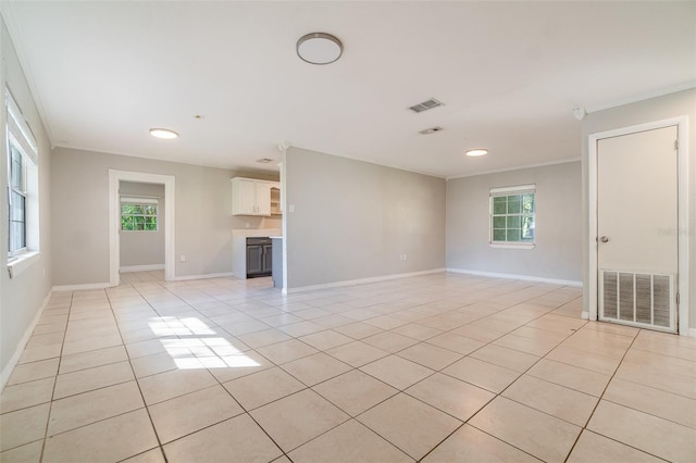 unfurnished living room featuring visible vents, crown molding, baseboards, and light tile patterned floors