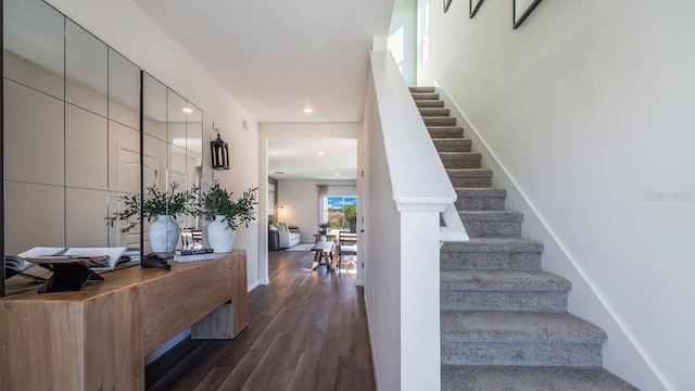 foyer with baseboards, stairway, dark wood-type flooring, and recessed lighting