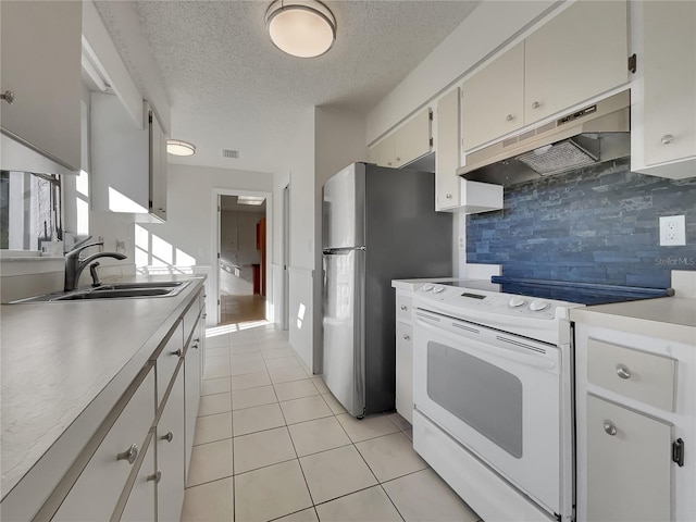 kitchen featuring light tile patterned floors, white electric range oven, light countertops, a sink, and under cabinet range hood